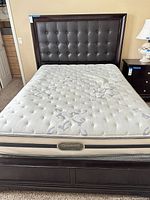 Front view of bed with headboard and Beautyrest mattress