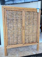 Front view of rattan wicker bamboo cabinet showing double doors