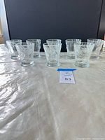 Front view of all eight clear embossed tumblers