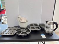 Group shot showing all baking pans, ice cream bowl, kettle with base