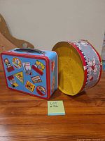 Lunch box front with travel stamp graphics, drum side view