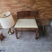 Overall lot showing chair, brass lamp with shade, brass magazine rack