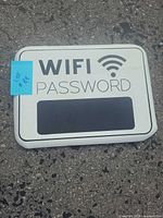 Front view of metal sign showing WiFi design and chalkboard area