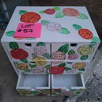 Front view showing six drawers and painted rose design