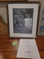 Framed print with mat and certificate visible