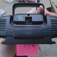 Rear view showing handle, battery compartment, brand label