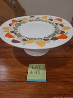 oblique view of ceramic cake stand showing mushroom border and pedestal base