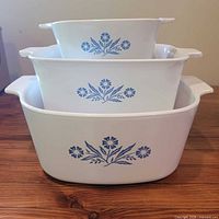 Three nested blue cornflower dishes showing pattern and sizes