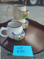 Three ceramic soup mugs stacked showing chick motif and cracker pockets