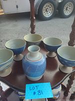 Front view showing five pedestal bowls and central jug