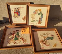 Group shot of all four framed needlepoints