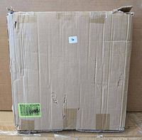Sealed cardboard shipping box containing the ottoman