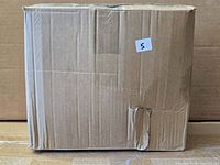 Sealed cardboard shipping box containing the product