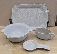 Full set displayed: platter, lidded bowl, handled bowl, spoon rest