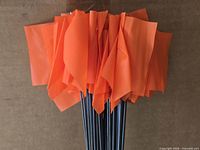 Bundle of orange flags on wire stakes