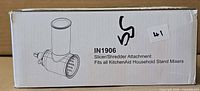 Retail box front showing line art of attachment and model