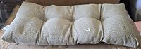 Entire cushion front view showing tufted sections