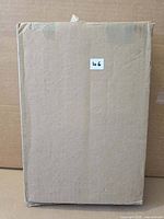 Sealed cardboard shipping box containing the canvas print