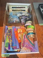 Top view of box showing tissue paper, ribbon spools and gift bags