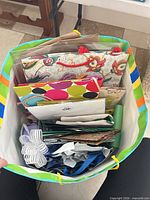 Top view into striped outer bag showing variety of gift bags and tissue paper