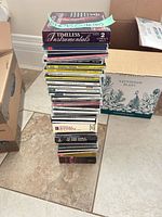Full stack of approximately 40 CD jewel cases and small box set