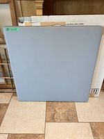 Front view of grey square tabletop showing vinyl surface