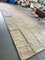 Full view of beige vinyl mat laid flat on garage floor