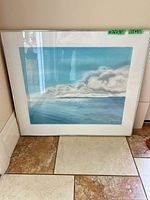 Full view of framed artwork leaning against wall