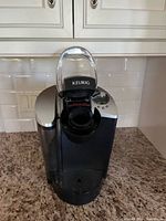 Front view of Keurig coffee maker with lid open