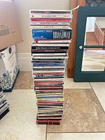 Tall stack of approx. 50 CD jewel cases