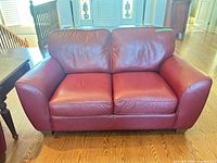 Front view of red leather Palliser loveseat
