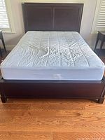 Front view of assembled queen bed frame with mattress
