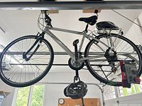 Full view of silver Rocky Mountain hybrid bicycle with rear rack and packaged lights