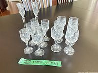 Full set of 14 cut crystal stem glasses on table