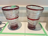Front view of both clear glass vases with red accents