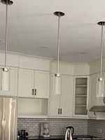 Three pendant fixtures installed over countertop showing overall style and finish