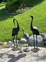 All three metal crane statues on patio