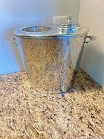Full view of silver-plated cooler with lid and handles