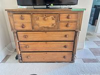 Front view showing seven drawers, wood finish, drawer layout