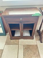 Front view of solid wood side cabinet showing doors and overall condition