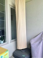 Umbrella stored in cover on resin base