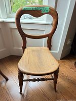 Front view showing balloon backrest, seat, and legs