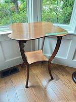 Full view of side table showing top, legs, shelf, overall form