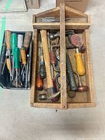 Wooden tote with assorted hammers, brace drill, shears, punches