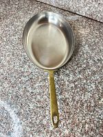 Full view of copper-clad skillet with brass handle