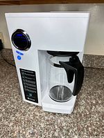 Front view showing control panel and glass carafe in place