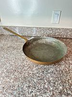 Top view of copper frying pan showing interior surface and diameter