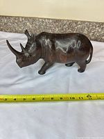 Left profile showing full figurine and tape for length measurement ~11 in