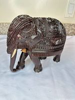 Right side view showing full carved body, bone tusks