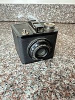 Front angled view of Kodak Brownie Special Six-20 camera showing lens, body covering and controls